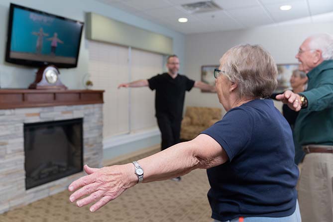Therapist leads exercise session in interactive session